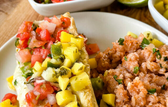 shrimp enchiladas on a plate with Spanish rice and pico de gallo