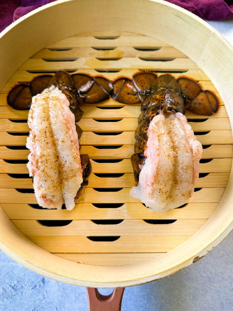 2 lobster tail in a steamer basket