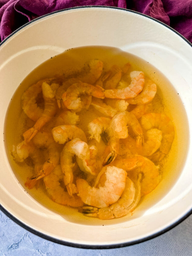 raw shrimp in a pot with hot water
