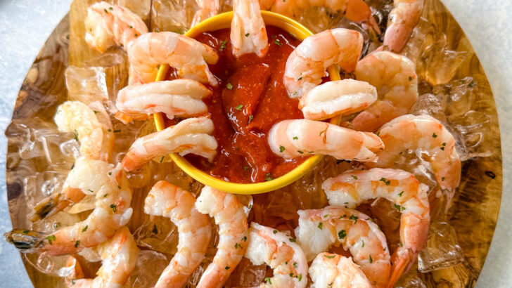 shrimp cocktail on a plate with ice and sauce