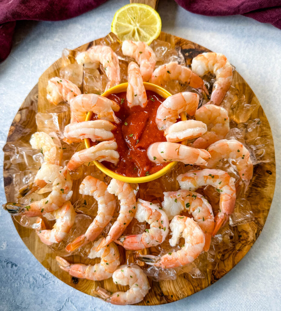 shrimp cocktail on a plate with ice and sauce