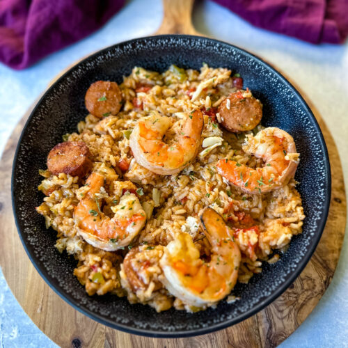 Creole shrimp jambalaya with crab in a black bowl