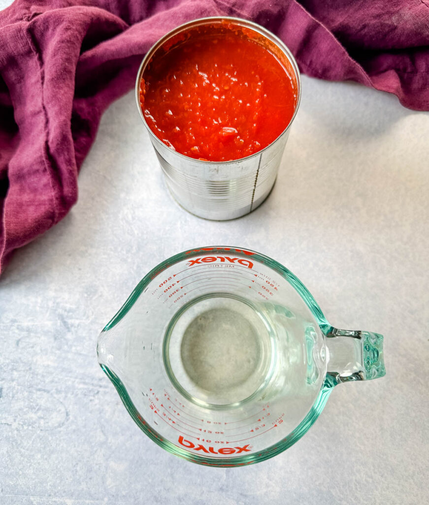 white wine and crushed tomatoes in separate containers