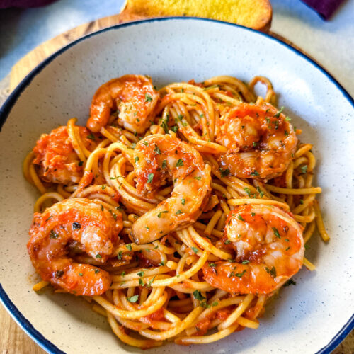 shrimp spaghetti with garlic in a white bowl