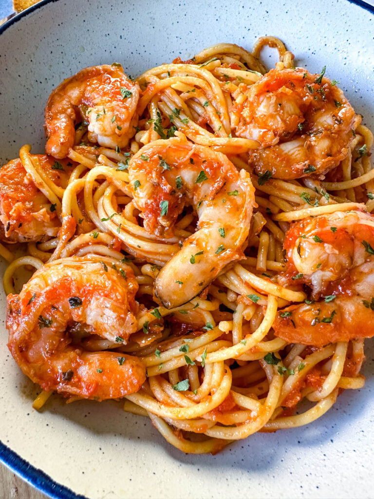 shrimp spaghetti with garlic in a white bowl