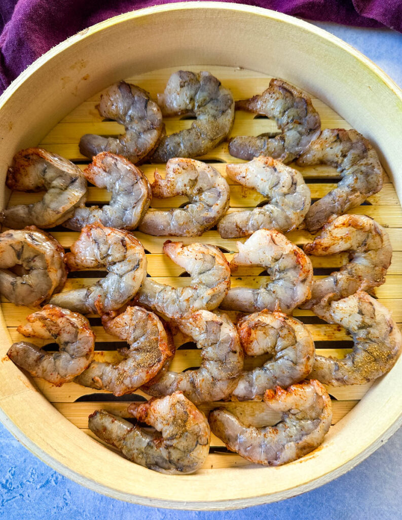 uncooked shrimp in a steaming basket
