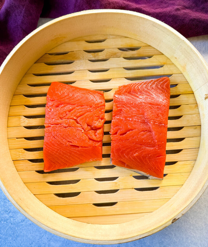 raw salmon in a steamer basket