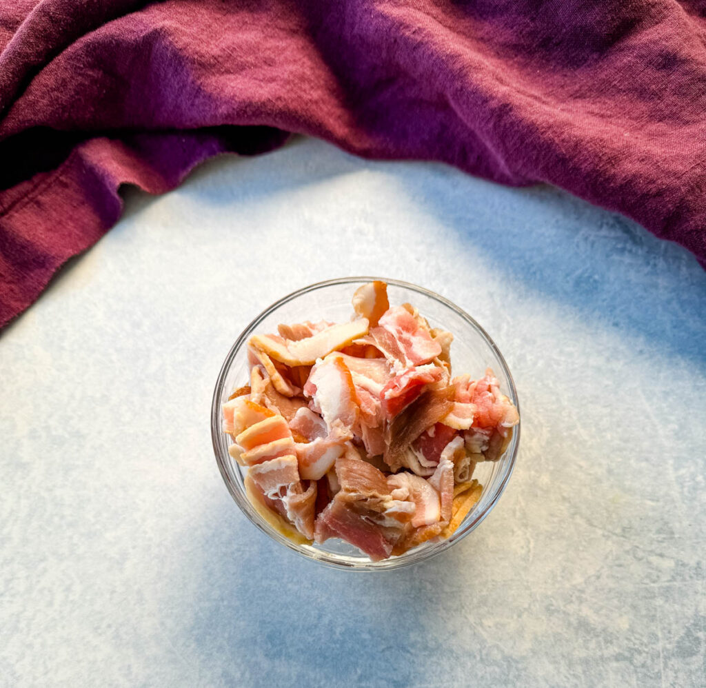 uncooked bacon in a glass bowl