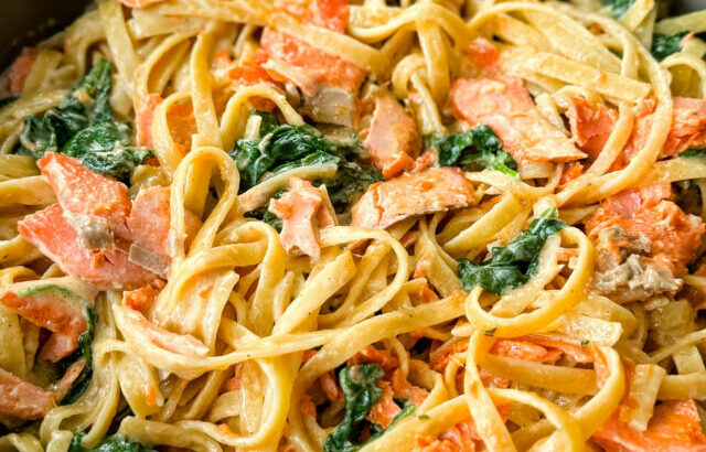 salmon Fettuccine Alfredo with spinach in a pan