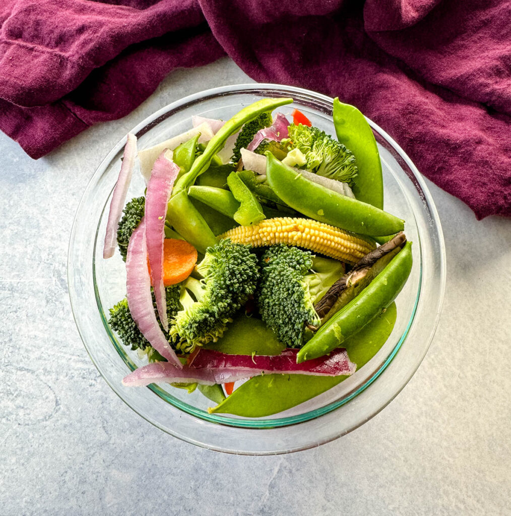 fresh stir fry vegetables in a glass bowl