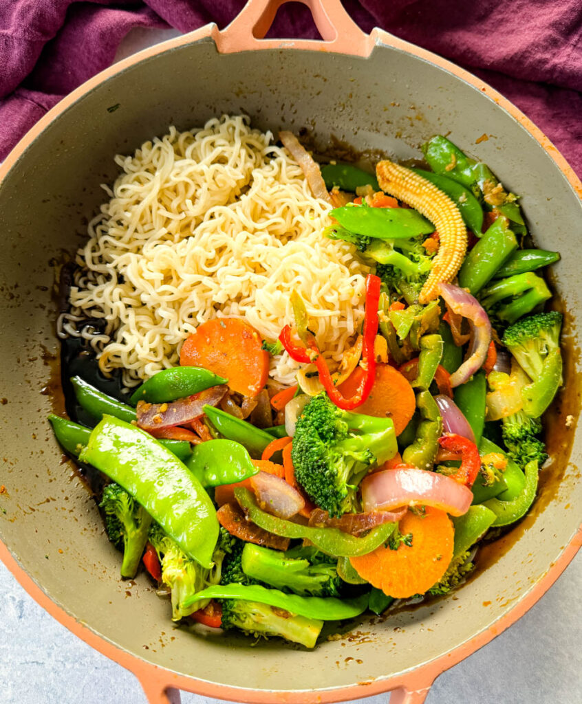 shrimp stir fry with noodles, vegetables, and a homemade sauce in a skillet